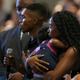 Dravon Ames, holding microphone, speaks to Phoenix Police Chief Jeri Williams and Phoenix Mayor Kate Gallego, as his fiancee, Iesha Harper, right, holds 1-year-old daughter London, at a community meeting, in Phoenix on Tuesday, June 18, 2019